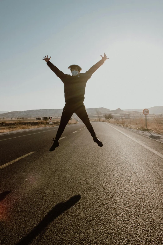 a person jumping in the air on a road, jordan lamarre - wan, looking happy, black, headspace