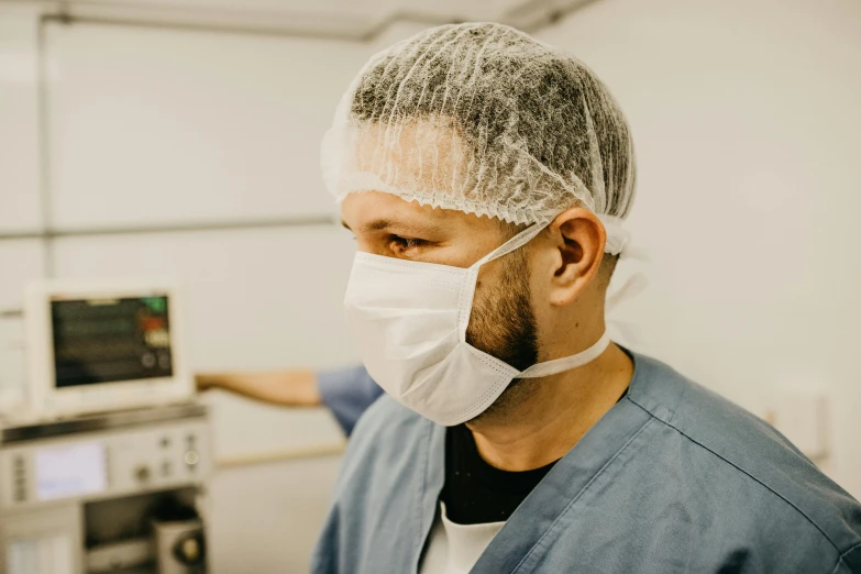 a close up of a person wearing a surgical mask, by Adam Marczyński, pexels contest winner, foxish guy in a lab coat, wearing a navy blue utility cap, surgery theatre, thumbnail