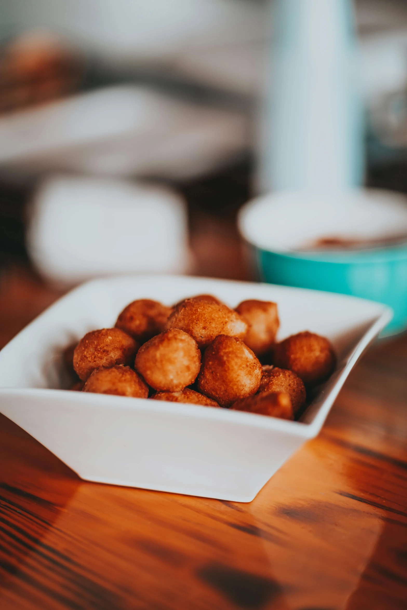 a close up of a bowl of food on a table, by Chris Rallis, unsplash, dau-al-set, chicken nuggets, puffballs, square, rum