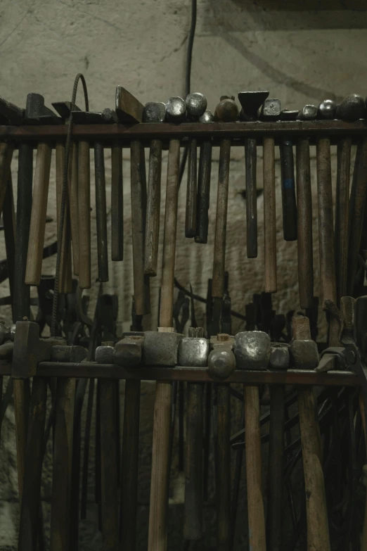 a bunch of tools sitting on top of a table, in a dungeon, documentary still, thumbnail, wall