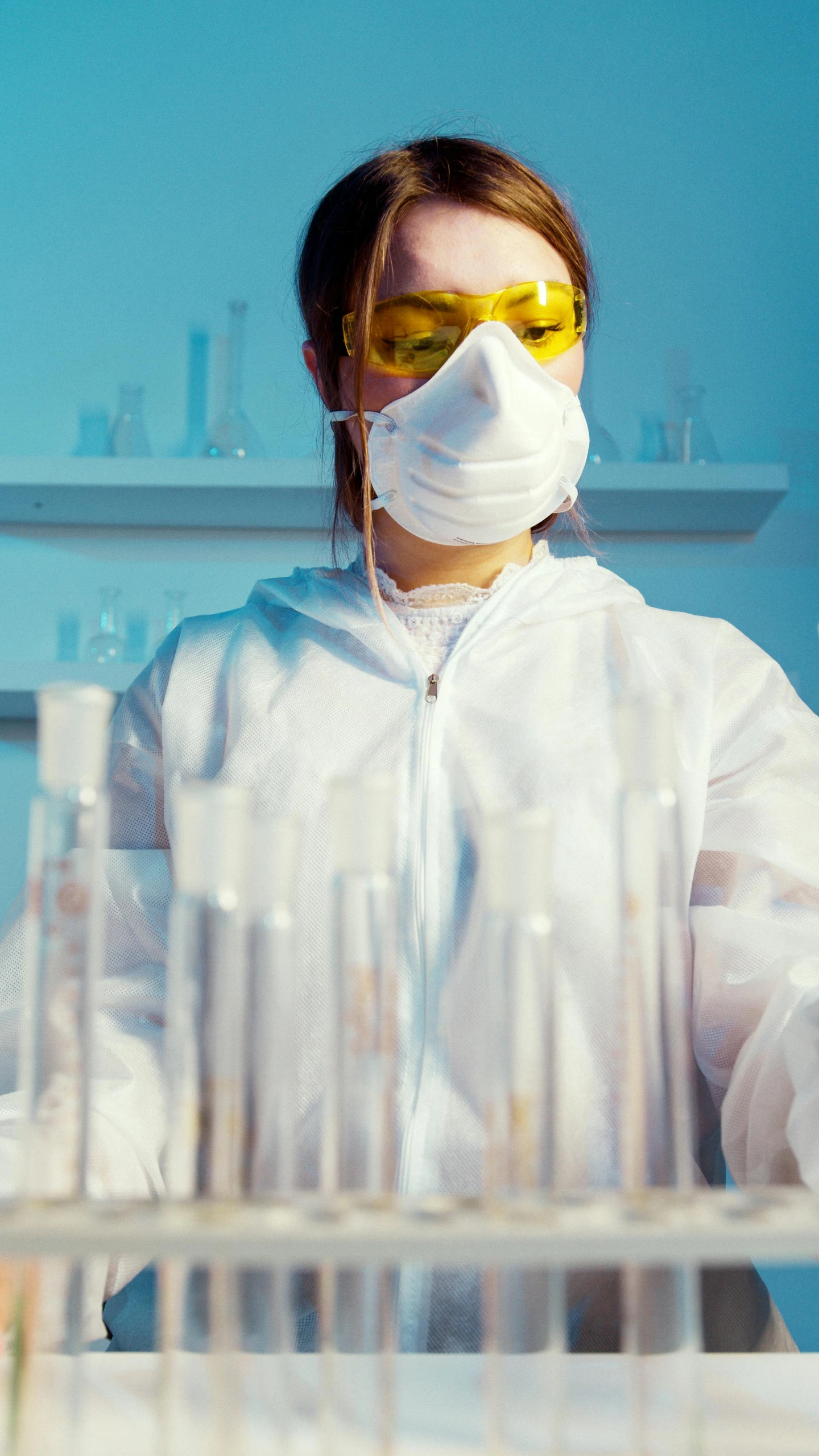 a woman in a lab coat and goggles working in a laboratory, by Adam Marczyński, shutterstock, color corrected, ruffles, snapchat photo, thumbnail
