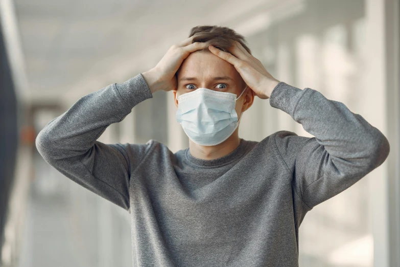 a man with a surgical mask covering his face, a picture, shutterstock, happening, recovering from pain, instagram photo, looking confused, professional image