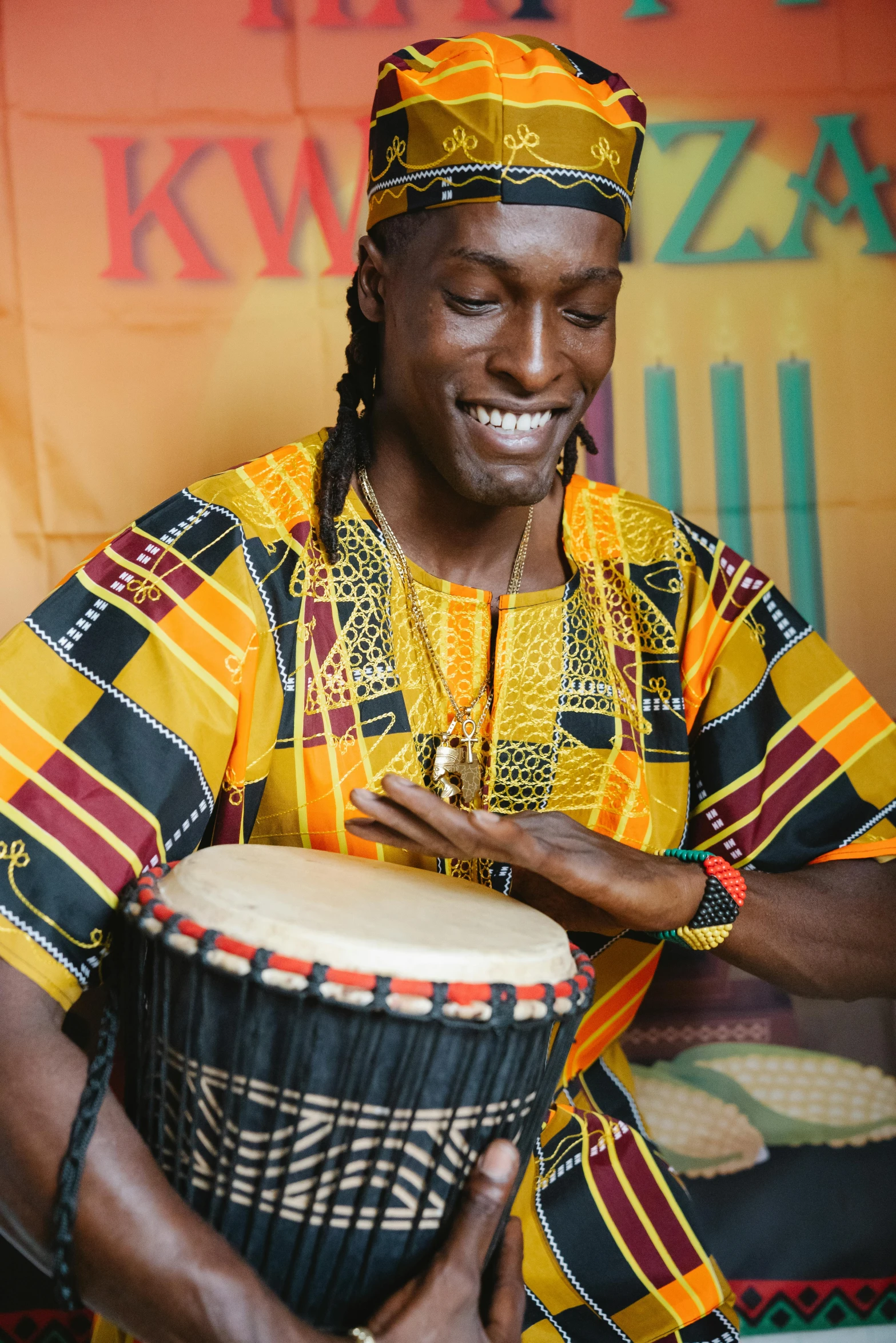 a man that is holding a drum in his hands, an album cover, inspired by Ras Akyem, pexels contest winner, thumbnail, multiple stories, traditional beauty, vibrant glow