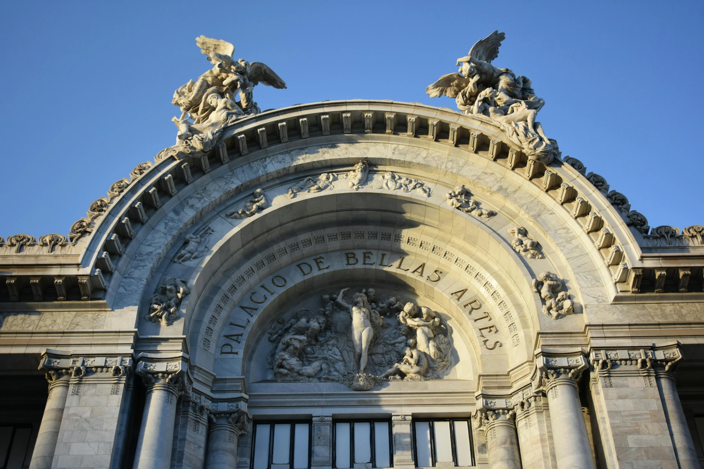 a large building with statues on top of it, a marble sculpture, inspired by Lajos Berán, pexels contest winner, art nouveau, round doors, buenos aires, avatar image