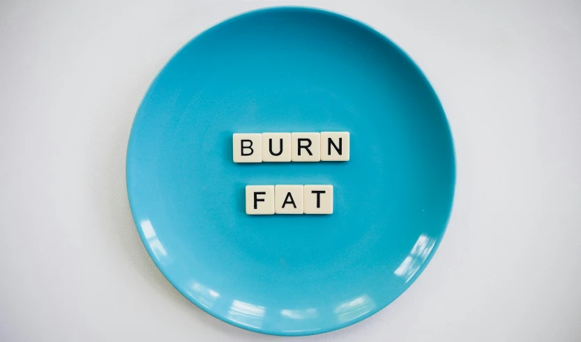 a blue plate with scrabbles spelling burn fat, by Georgina Hunt, hurufiyya, cottagecore!! fitness body, thumbnail, workout, round-cropped