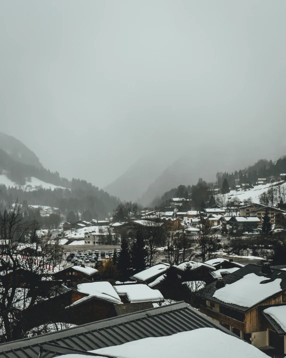 a view of a town covered in snow, gloomy and foggy atmosphere, the middle of a valley, festivals, unsplash photography