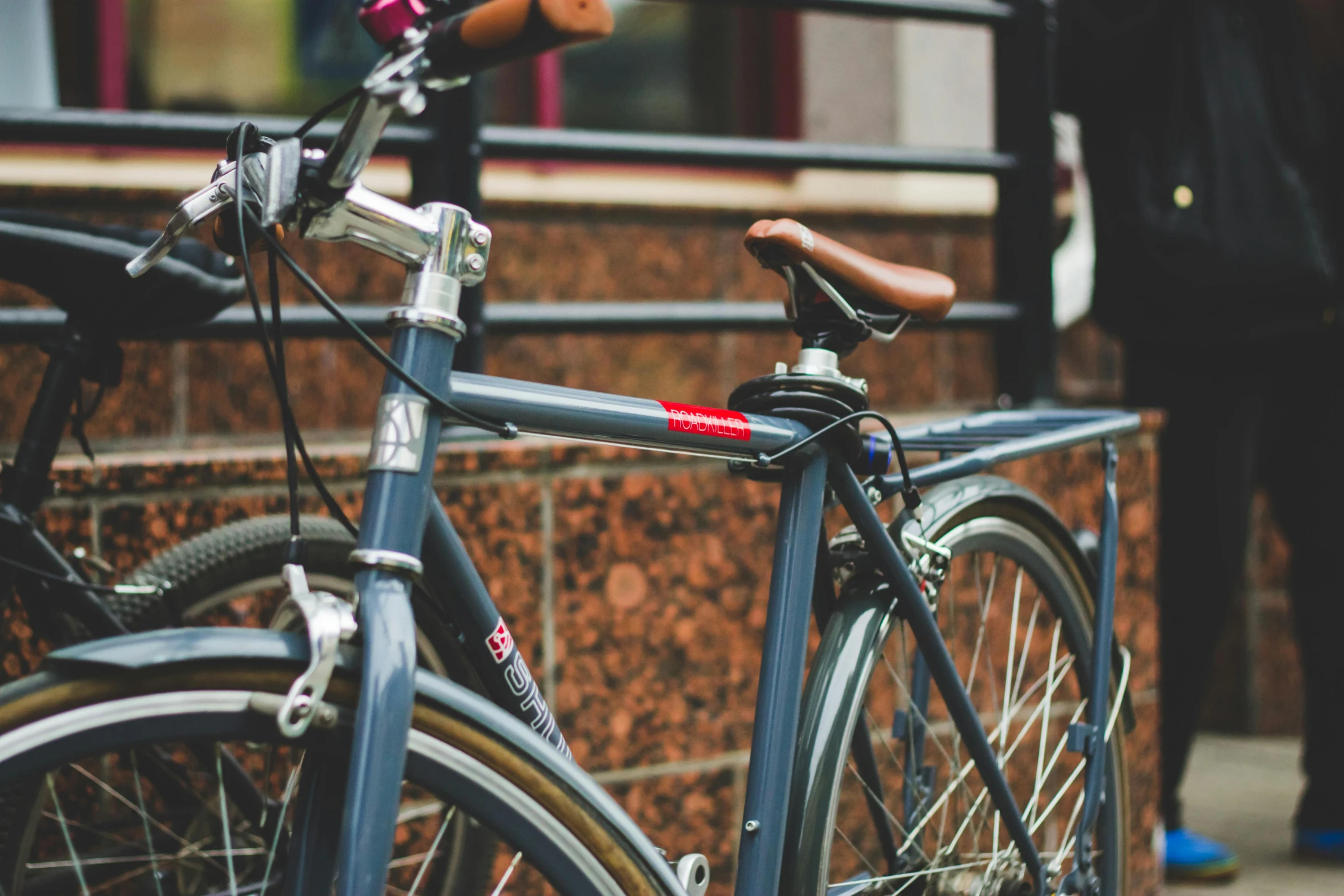 a close up of a bicycle parked in front of a building, by Carey Morris, unsplash, profile pic, 🎨🖌️, mechanical details, around the city