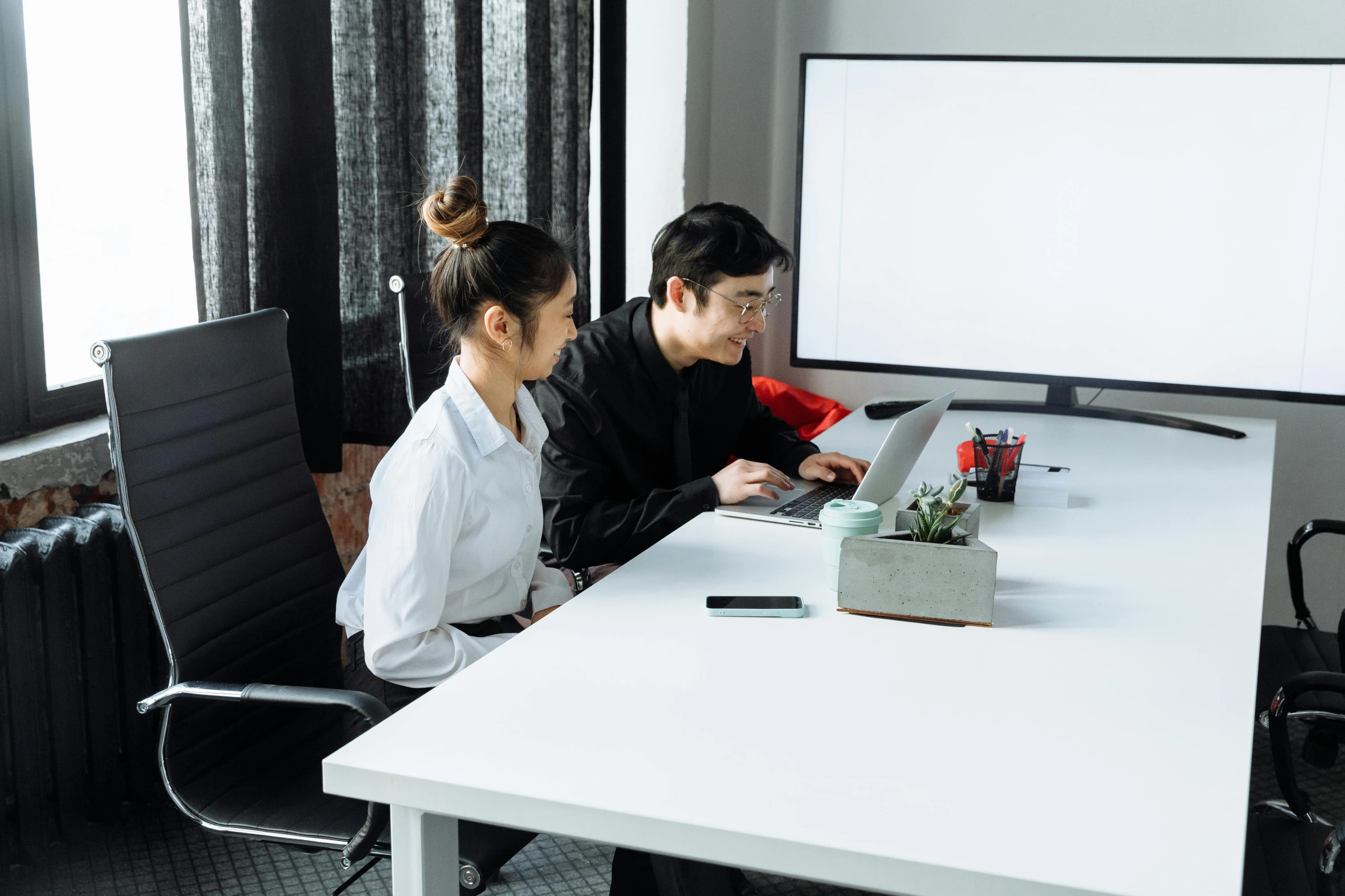 a couple of people that are sitting at a table, trending on unsplash, computer art, whiteboards, kyoto studio, office clothes, wikimedia commons