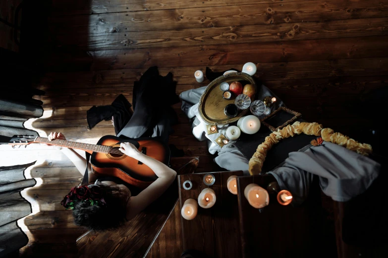 a group of people sitting around a table with candles, an album cover, inspired by Elsa Bleda, pexels contest winner, vanitas, is playing a lute, cosplay photo, 15081959 21121991 01012000 4k, sensual gloomy