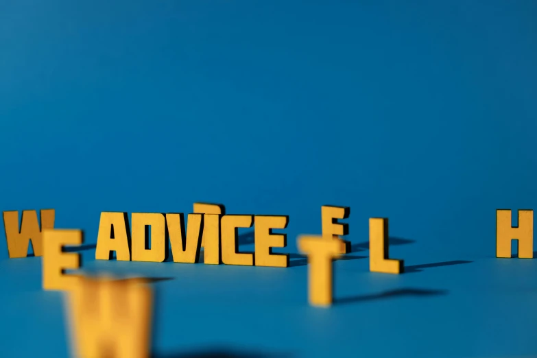 a group of wooden letters sitting on top of a blue surface, a tilt shift photo, by Adam Marczyński, reddit, on a yellow canva, flcl, new adventure, dwell