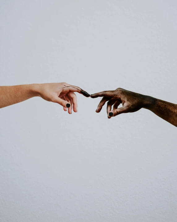 two hands reaching towards each other, by Lucia Peka, trending on pexels, minimalism, with grey skin, mixed race, attractive photo, lgbtq