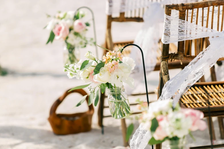 a row of chairs sitting on top of a sandy beach, bouquets, lots of details, zoomed in, interior shot