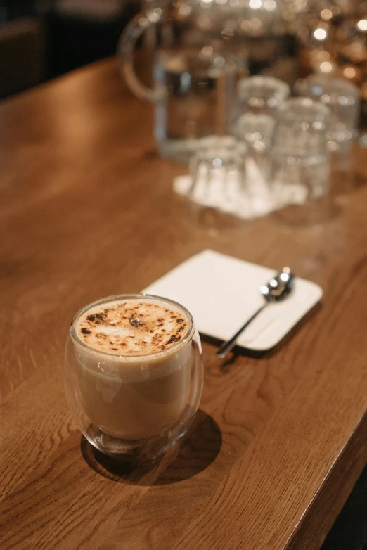 a cup of coffee sitting on top of a wooden table, award-winning crisp details”, thumbnail, brown, vanilla