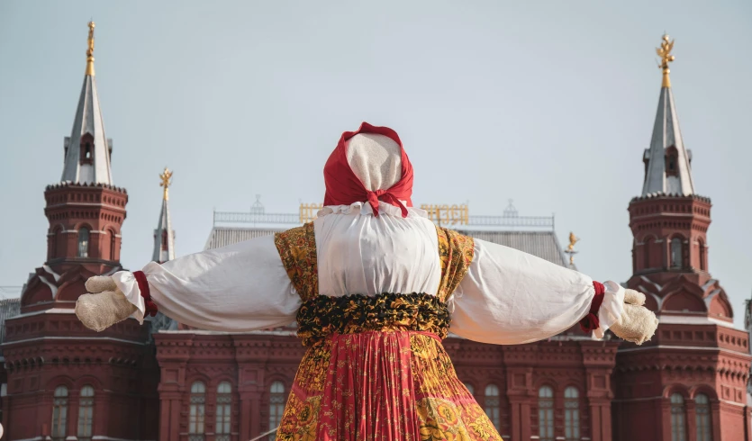 a statue of a person standing in front of a building, by Attila Meszlenyi, pexels contest winner, russian costume, an ahoge stands up on her head, square, filling the frame