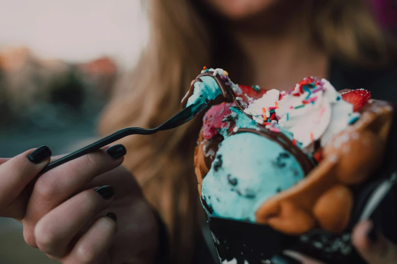 a woman holding a spoon full of ice cream, trending on pexels, blue colors with red accents, black and aqua colors, messy eater, 🦩🪐🐞👩🏻🦳