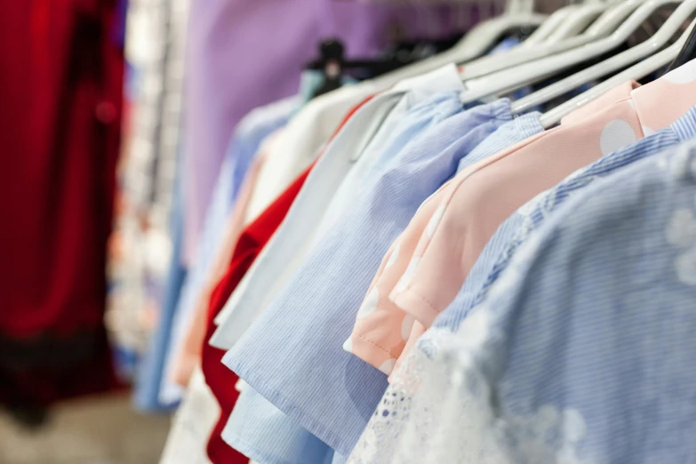 a bunch of shirts hanging on a rack, by Joe Bowler, trending on unsplash, wearing dresses, bright uniform background, 15081959 21121991 01012000 4k, market stalls
