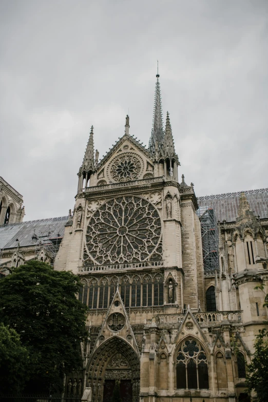 a large cathedral with a clock on it's side, gray skies, cinematic paris, tiny ornate windows, high-quality photo