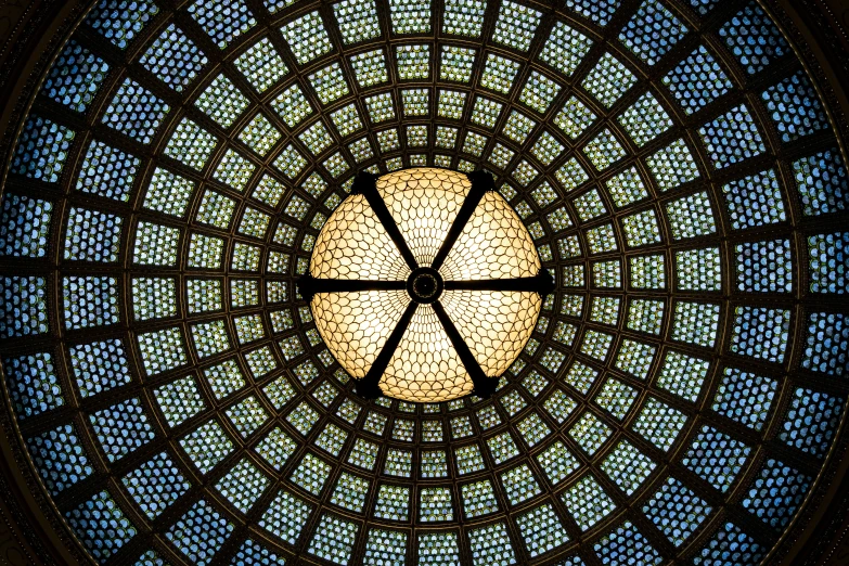 a circular stained glass window in a building, a mosaic, by Lubin Baugin, flickr, lights on ceiling, chicago, symmetrical background, glass dome