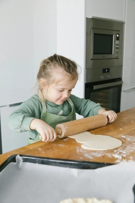 a little girl rolling out dough on a table, pexels, indi creates, kek, full product shot, large tall