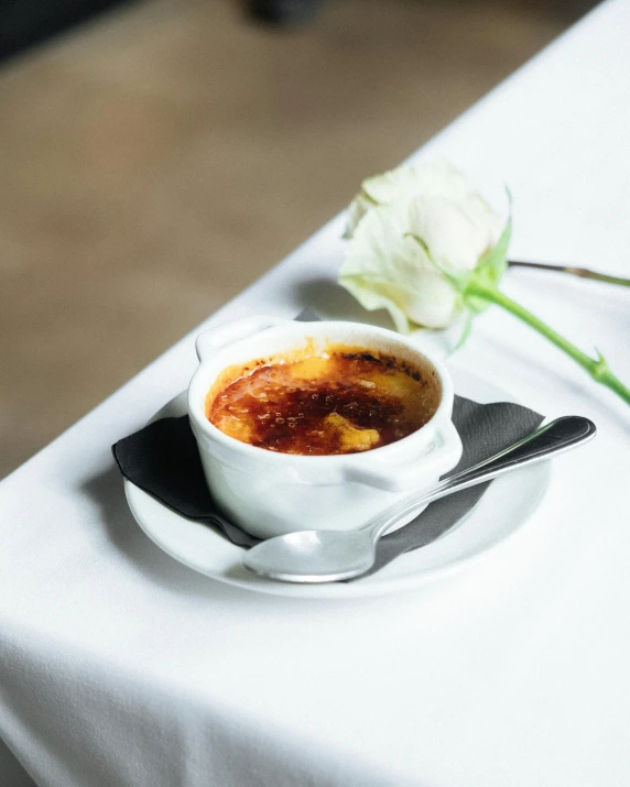 a close up of a plate of food on a table, inspired by Charles Le Roux, unsplash, flan, square, white, molten