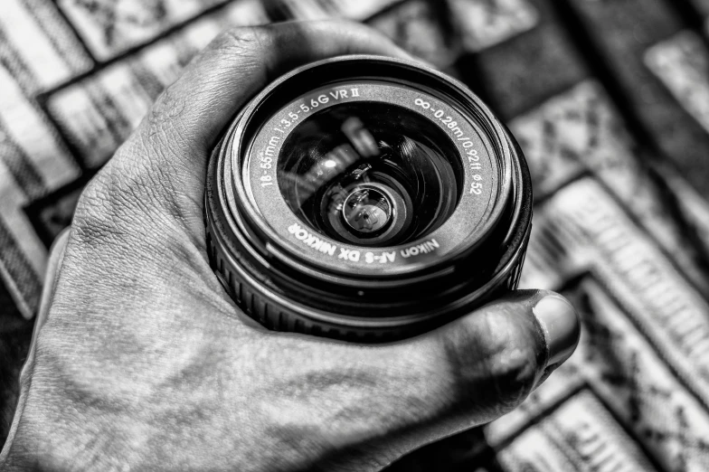 a black and white photo of a person holding a camera, by Mathias Kollros, pexels contest winner, photorealism, fisheye!!!!! lens!!!!!, today\'s featured photograph 4k, but as macro!!!!! photography, focus on the object