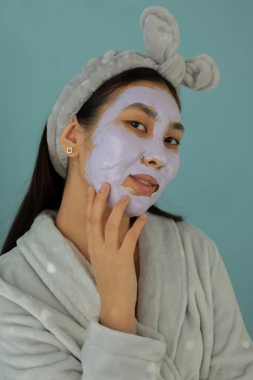 a woman in a bathrobe with a sheet on her face, reddit, happening, smooth purple skin, set on singaporean aesthetic, promo image, powder