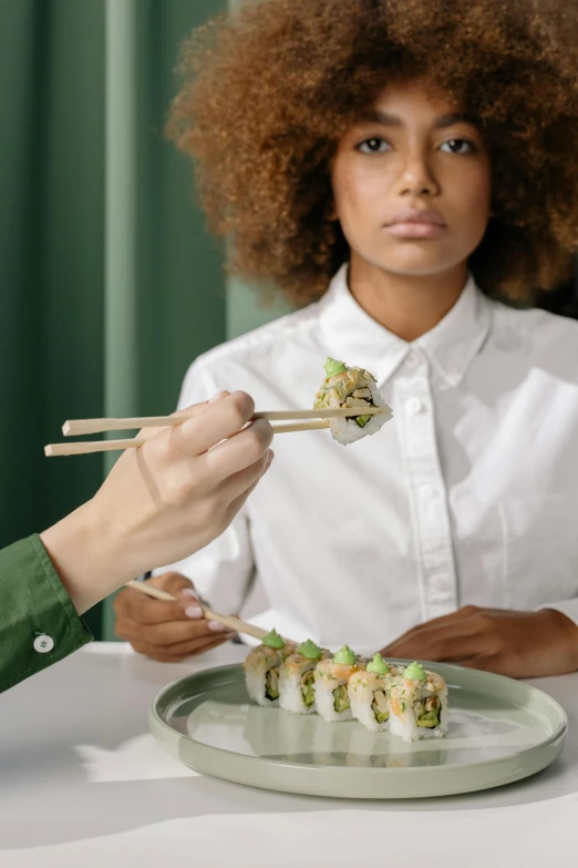 a woman eating sushi with chopsticks at a table, inspired by Maki Haku, trending on unsplash, renaissance, samurai with afro, green, symetrical japanese pearl, made of food