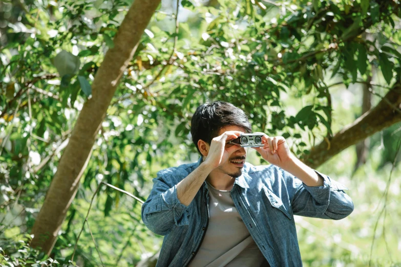 a man taking a picture with a camera, unsplash, happening, amongst foliage, ar glasses, mark edward fischbach, press shot