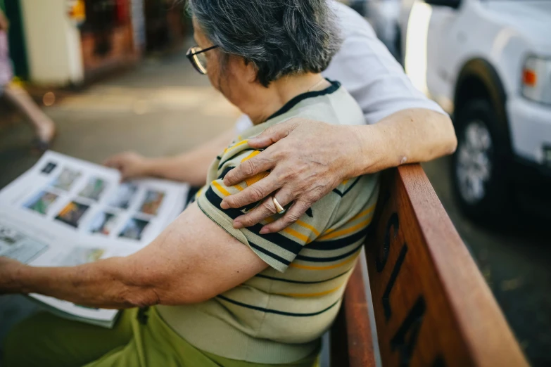 a woman sitting on a bench reading a newspaper, pexels contest winner, photorealism, hugging each other, an elderly, showing her shoulder from back, large highlights
