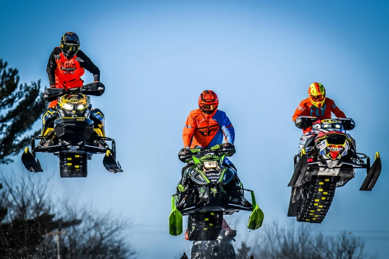 a group of people riding snowmobiles in the air, a portrait, pexels contest winner, figuration libre, chartreuse and orange and cyan, stacked image, racing, kawasaki