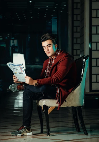 a man sitting in a chair reading a newspaper, an album cover, pexels contest winner, justin sun, casual pose, hasbulla magomedov, avatar image