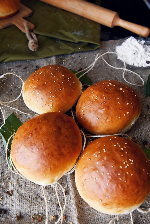 a bunch of buns sitting on top of a table, hurufiyya, 4l, single, tamborine, hasselblatt