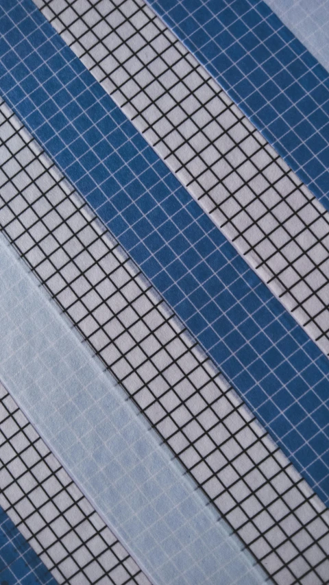 a close up of a tie on a table, a mosaic, inspired by Agnes Martin, unsplash, op art, grid of styles, blue-fabric, thumbnail, multi-part