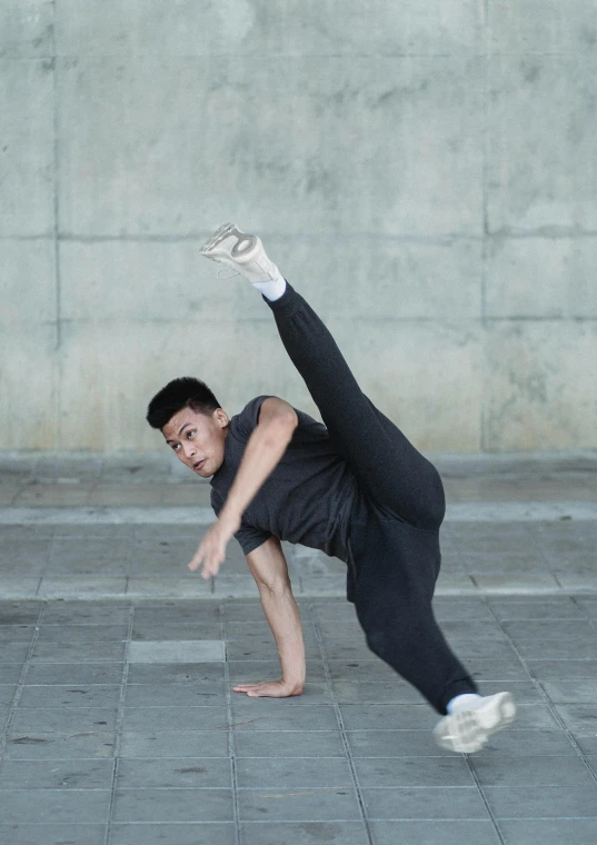 a man doing a handstand on a sidewalk, inspired by Fei Danxu, dynamic skating, phong yintion j - jiang geping, profile picture, asher duran