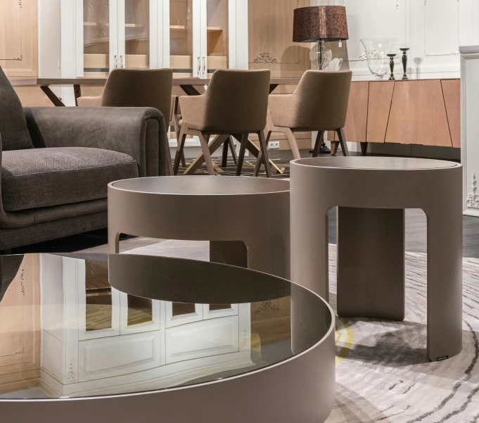 a living room filled with furniture and a fire place, inspired by Emilio Grau Sala, trending on cg society, altermodern, sitting on a mocha-colored table, curved hallways, circle forms, lacquered glass
