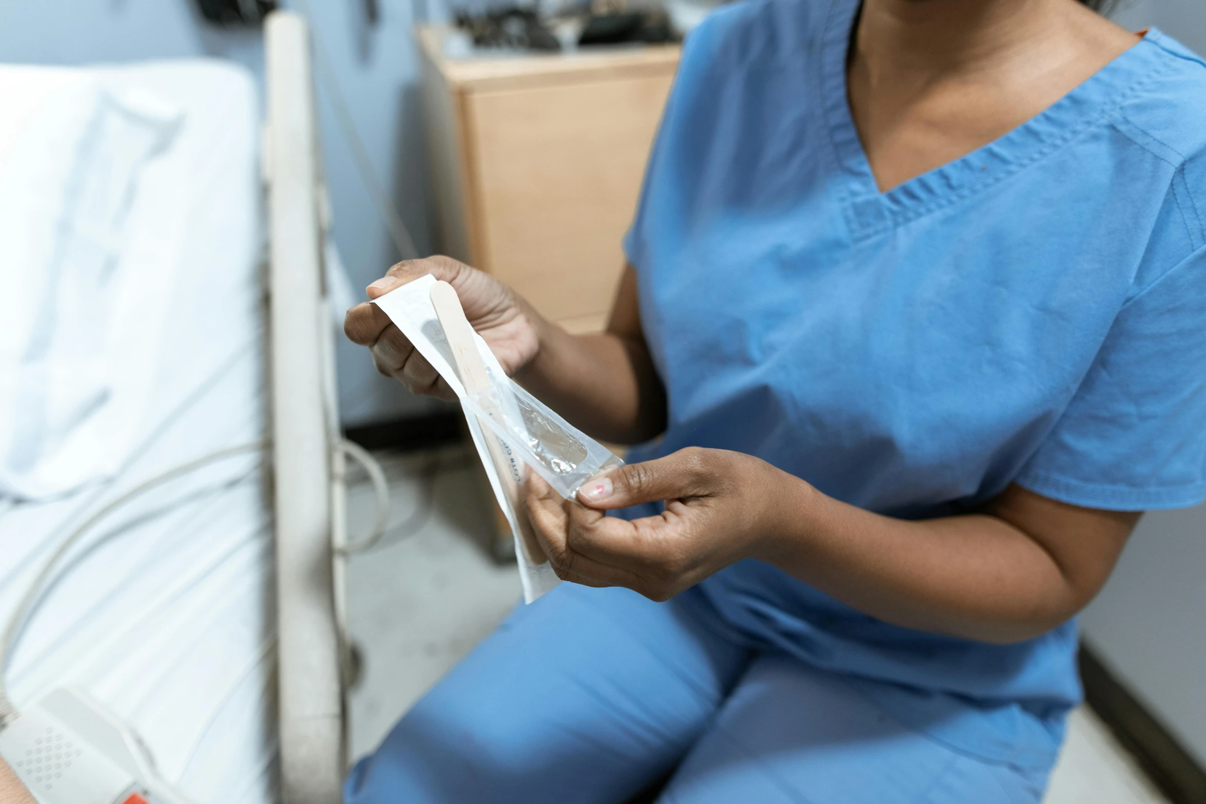 a woman sitting next to a man in a hospital bed, pexels contest winner, hurufiyya, cracked plastic wrap, woman holding another woman, inspect in inventory image, detail shot