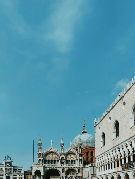 a group of people walking down a street next to tall buildings, inspired by Quirizio di Giovanni da Murano, pexels contest winner, baroque, palace floating in the sky, clear blue skies, thumbnail, dome