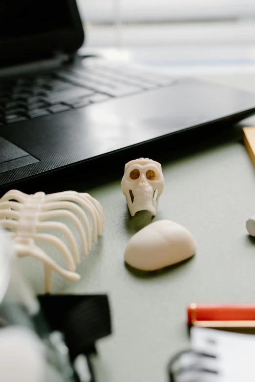 a laptop computer sitting on top of a desk, academic art, bone and ivory, modelling clay, scientist, product design