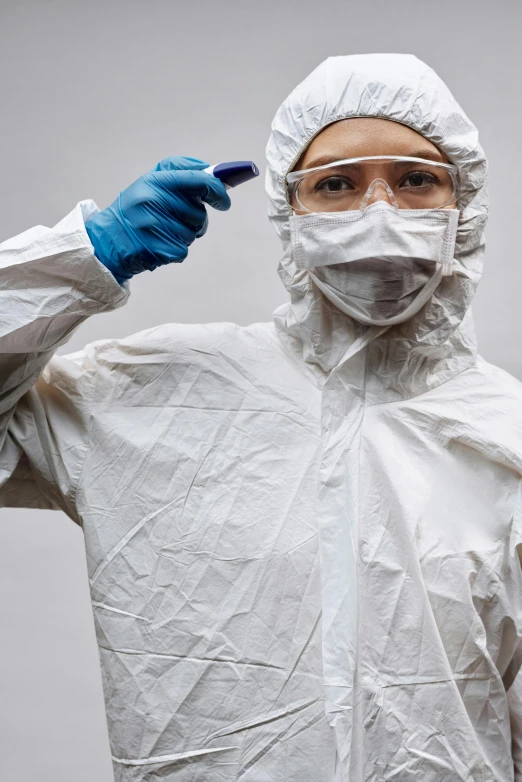 a man in a protective suit brushing his teeth, an album cover, shutterstock, plasticien, female investigator, asian hyperdetailed, lab coat, taken in 2 0 2 0