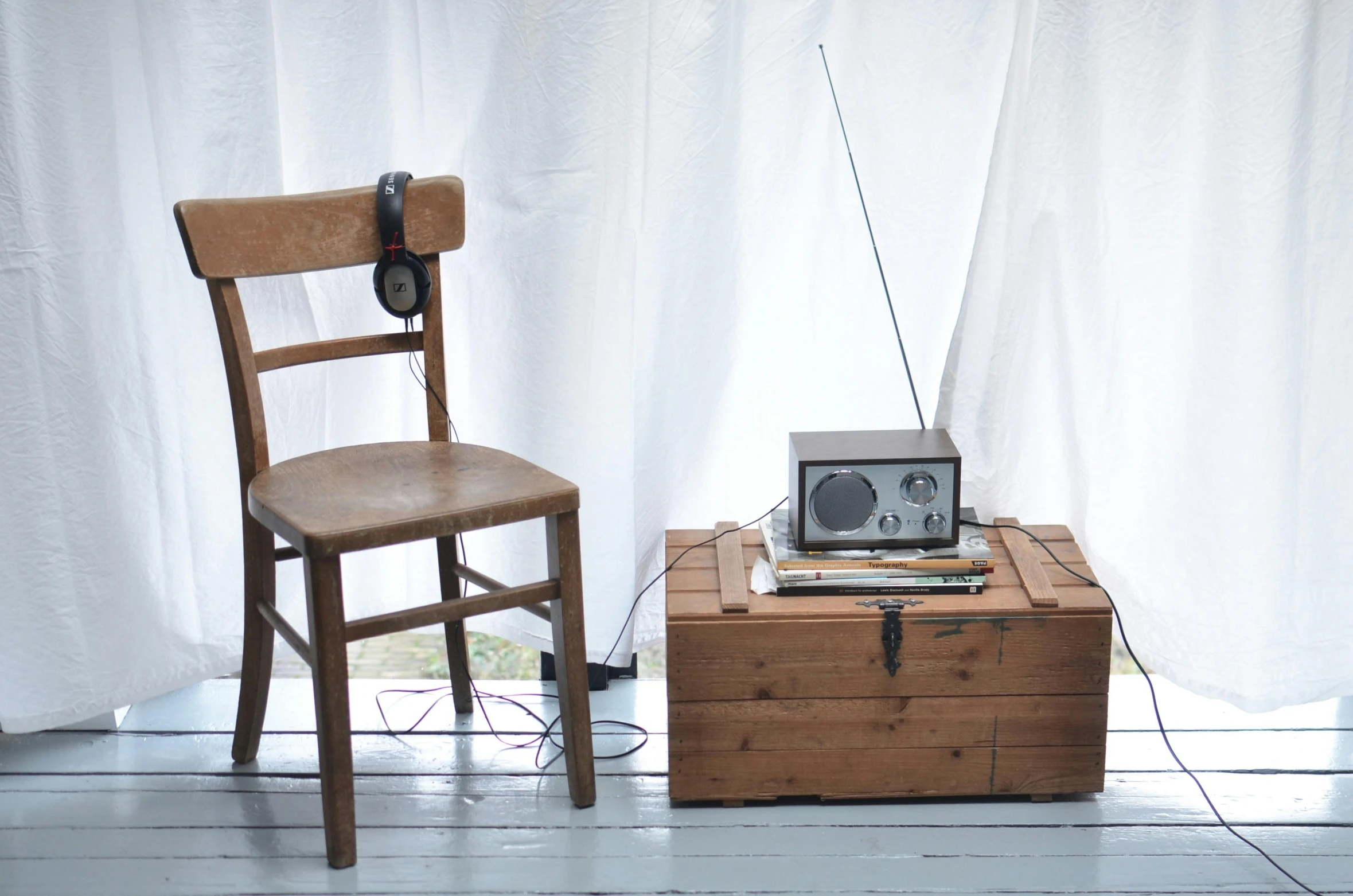 a radio sitting on top of a wooden box next to a chair, inspired by Joseph Beuys, arte povera, full body photograph, a quaint, white, shot on sony a 7