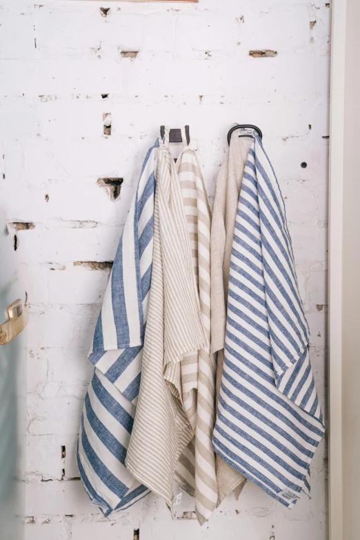 a bunch of towels hanging on a wall, square lines, studio spotlight, ballard, farms