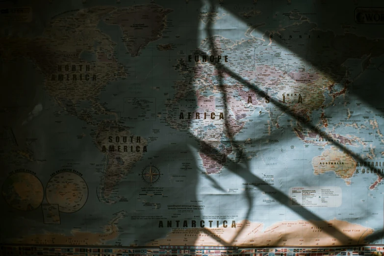 a close up of a map on a wall, pexels contest winner, great light and shadows”, background image, silhouetted, window light