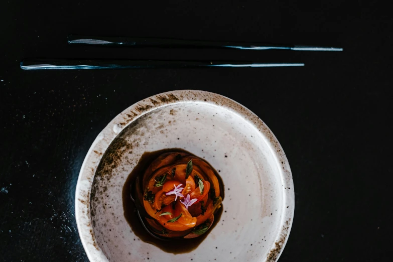 a close up of a plate of food with chopsticks, unsplash contest winner, purism, black and terracotta, chefs table, thumbnail, restaurant menu photo