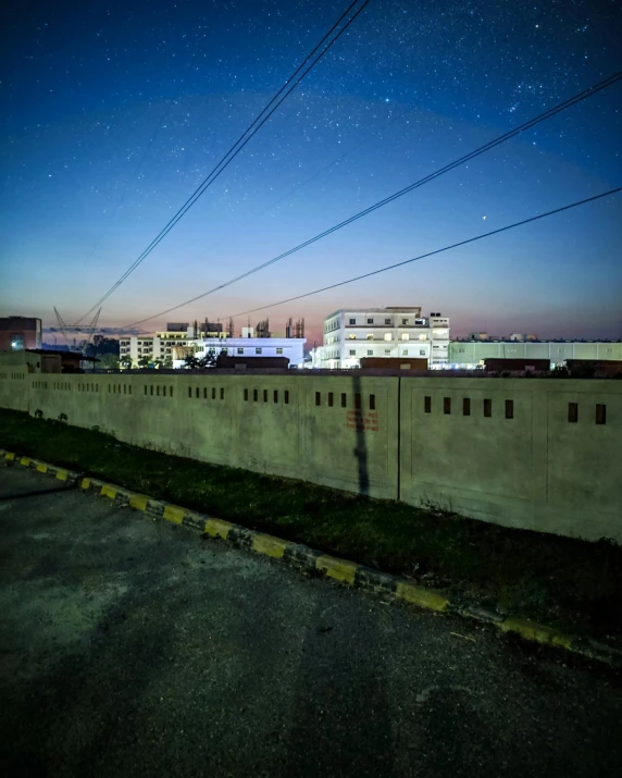 a city at night with power lines in the foreground, by Kristian Zahrtmann, concrete walls, medical complex, khyzyl saleem, profile image