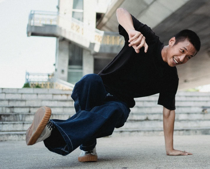 a man is doing a trick on a skateboard, pexels contest winner, happening, males and females breakdancing, dramatic smiling pose, asian male, wearing a tee shirt and combats