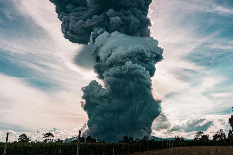 a large plume of smoke rises into the sky, a picture, by Jesper Knudsen, unsplash contest winner, sumatraism, towering cumulonimbus clouds, ground explosion, taken in 2022, ash falling