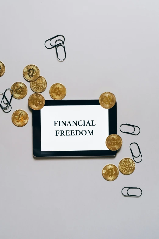 a tablet computer sitting on top of a pile of coins, a digital rendering, inspired by Benjamin Franklin, trending on pexels, freedom, fra, crypto, with text