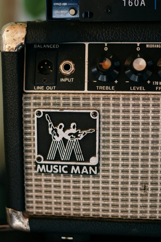 a guitar amp sitting on top of a table, an album cover, by Murray Tinkelman, trending on unsplash, modernism, invisible man, ( ( theatrical ) ), by wes wilson, manic