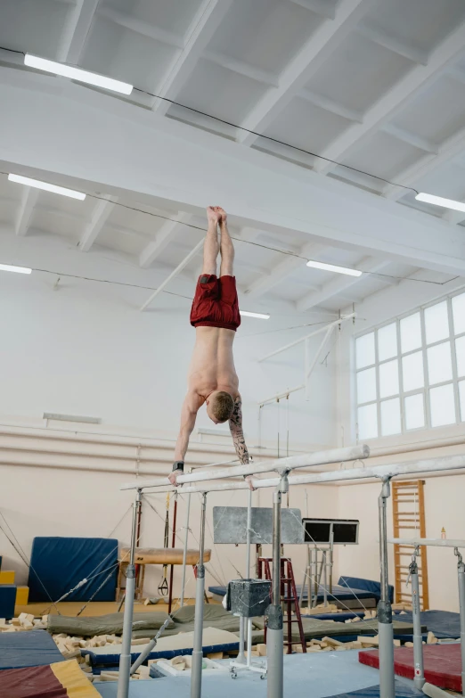 a person on a balance beam in a gym, by Ilya Ostroukhov, arabesque, cai xukun, square, b - roll, circus