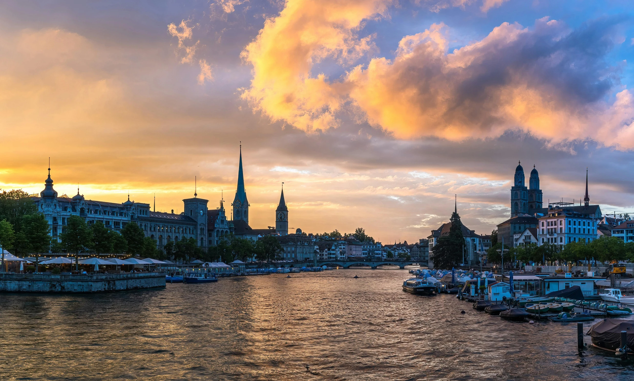 a river filled with lots of boats under a cloudy sky, by Sebastian Spreng, pexels contest winner, romanticism, photo of zurich, golden hour”, thumbnail, majestic spires